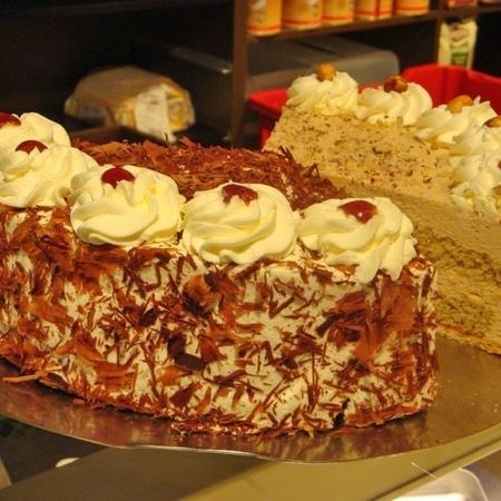 Kuchenstück mit Sahne und gemischten Beeren auf goldener Oberfläche